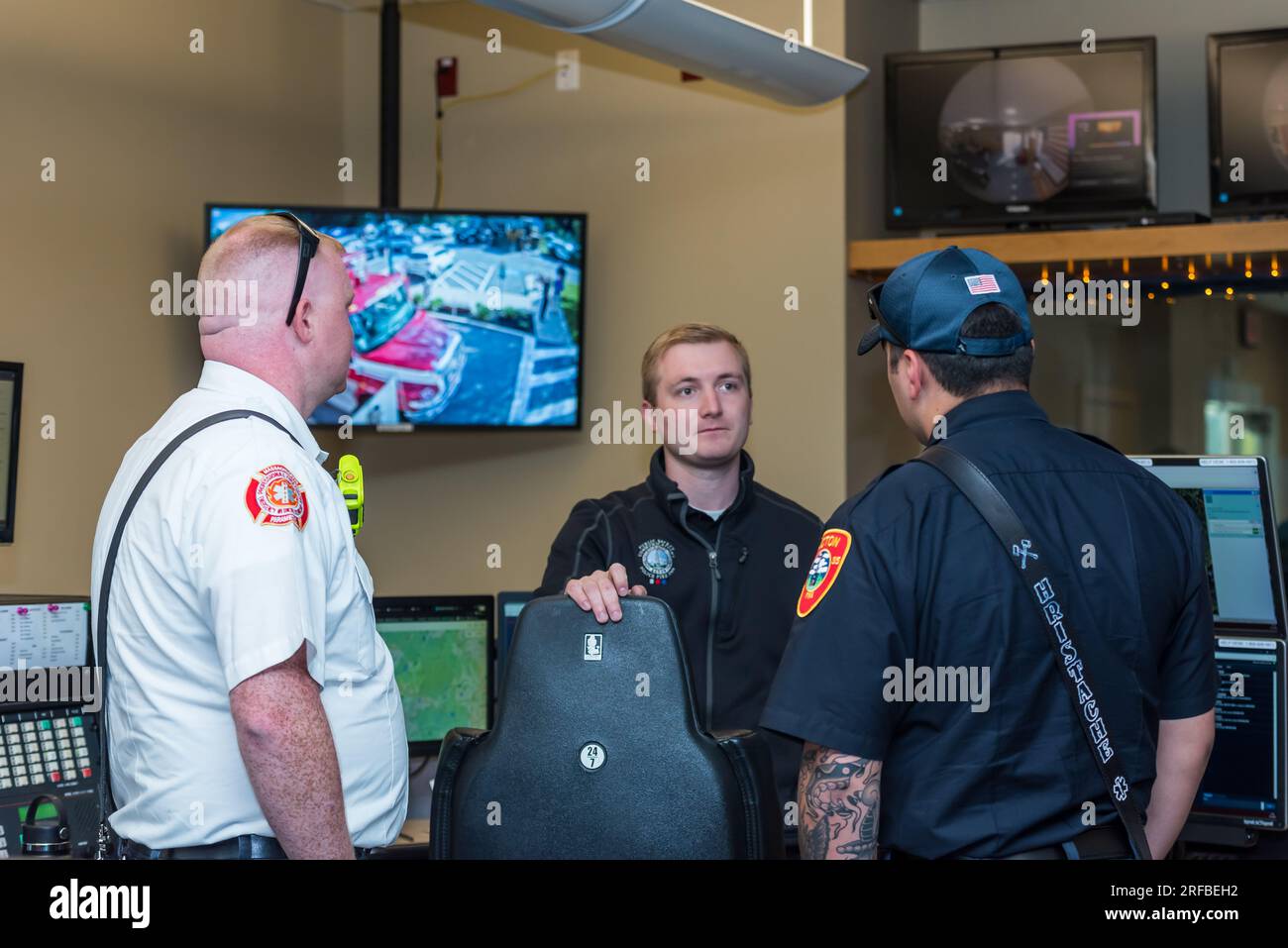 Safety Dispatcher, Brendan Gray, speaking with Acton firefighters at