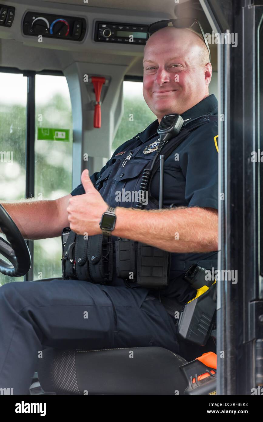 Acton Police officer sitting in Acton DPW truck at National Night Out