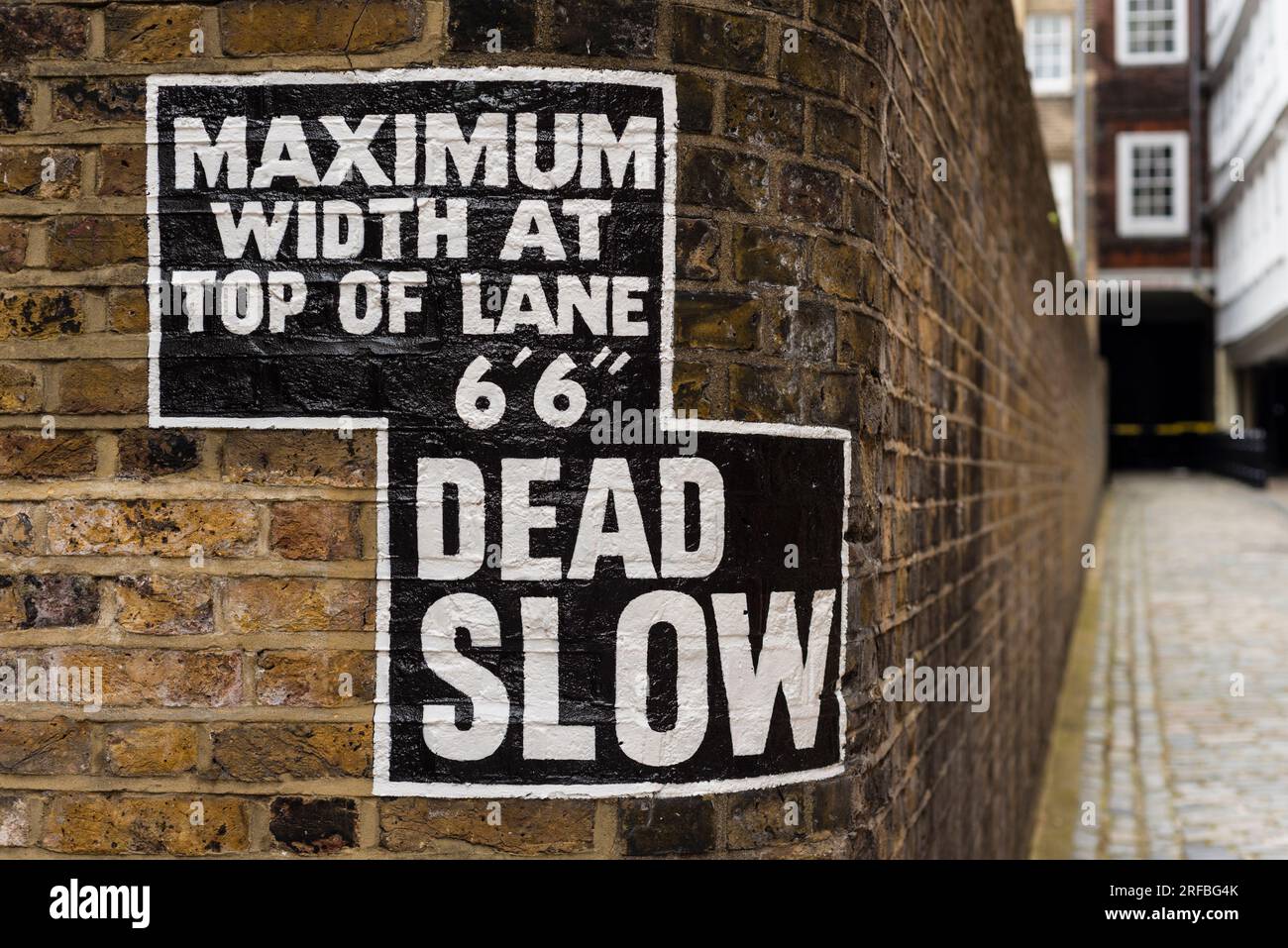 Sign of width restriction and asking to drive slow, Inns of Court, London, UK Stock Photo