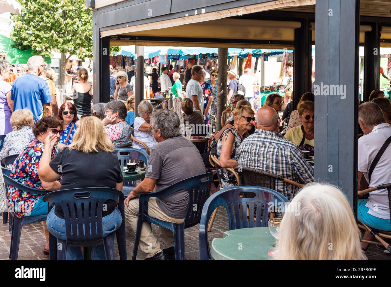 People in street cafe on market day, Marseillan, Herault, Occitanie, France Stock Photo