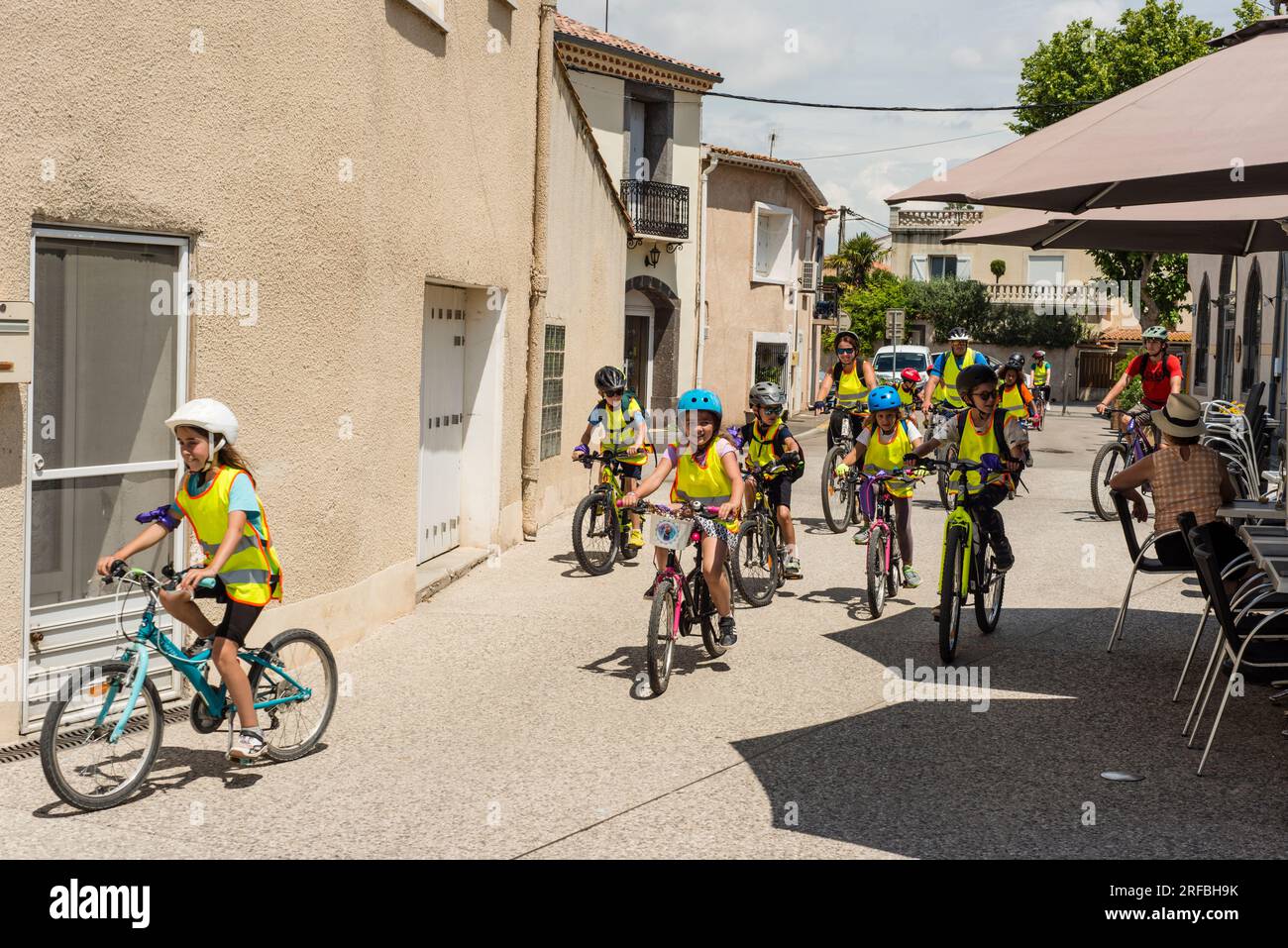 Young school children on bicycles, Marseillan, Herault, Occitanie, France Stock Photo