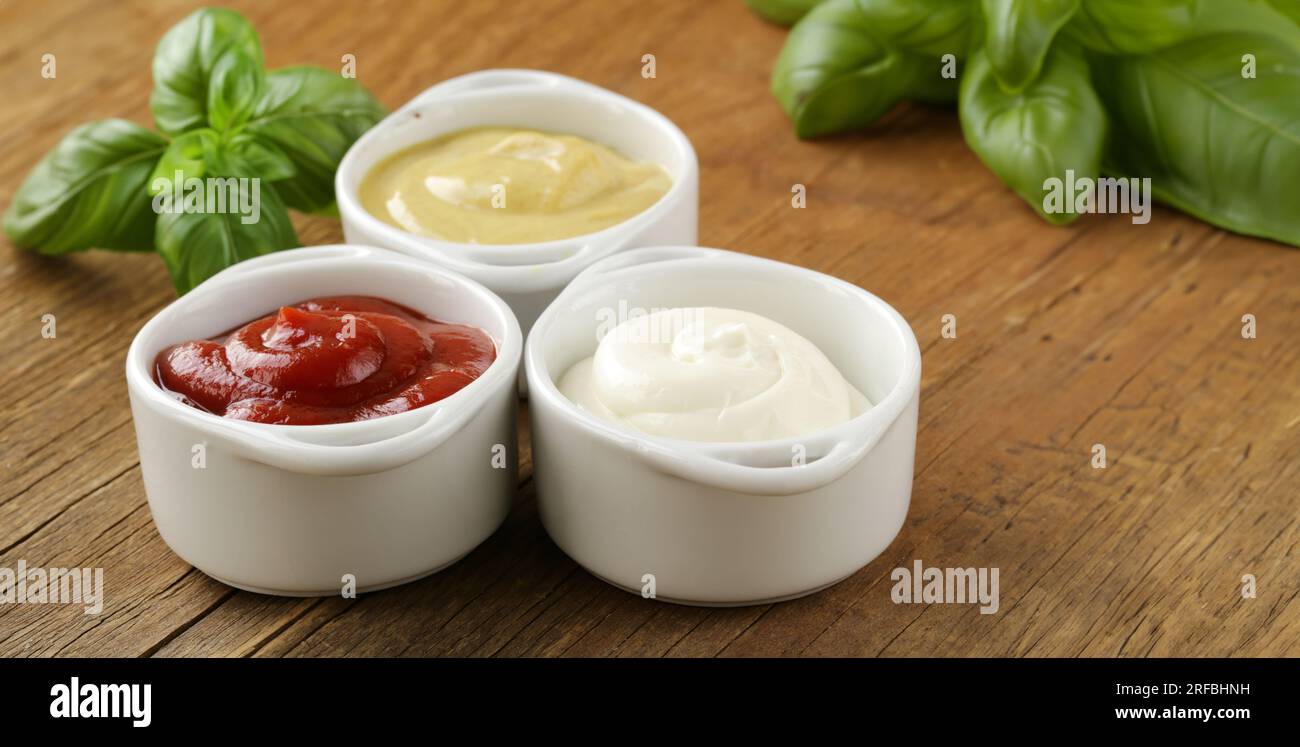 three types of sauces ketchup, mayonnaise and mustard Stock Photo Alamy