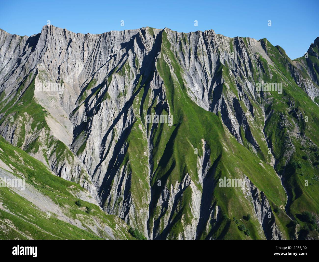 AERIAL VIEW. Steep hill side with multiple ravines in the Western side of the Vanoise Massif. Les Pâturées, Savoie, Auvergne-Rhône-Alpes, France. Stock Photo