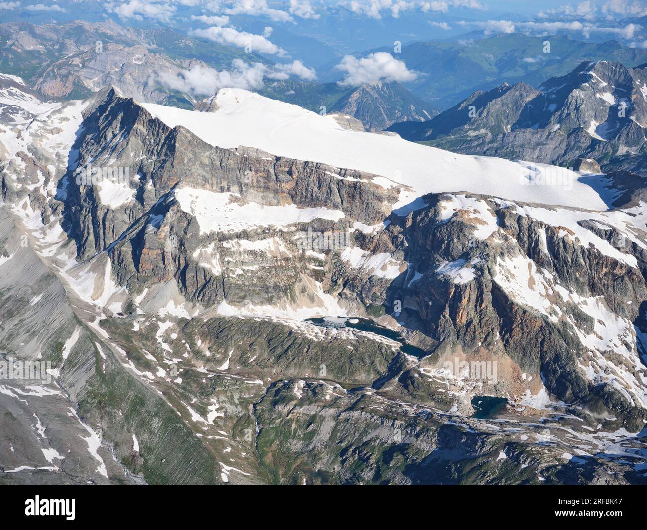 AERIAL VIEW. La Roche Ferran Glacier and the east-facing cliff between Mont Pelve and Roche Ferran in the Vanoise Massif. Savoie, France. Stock Photo