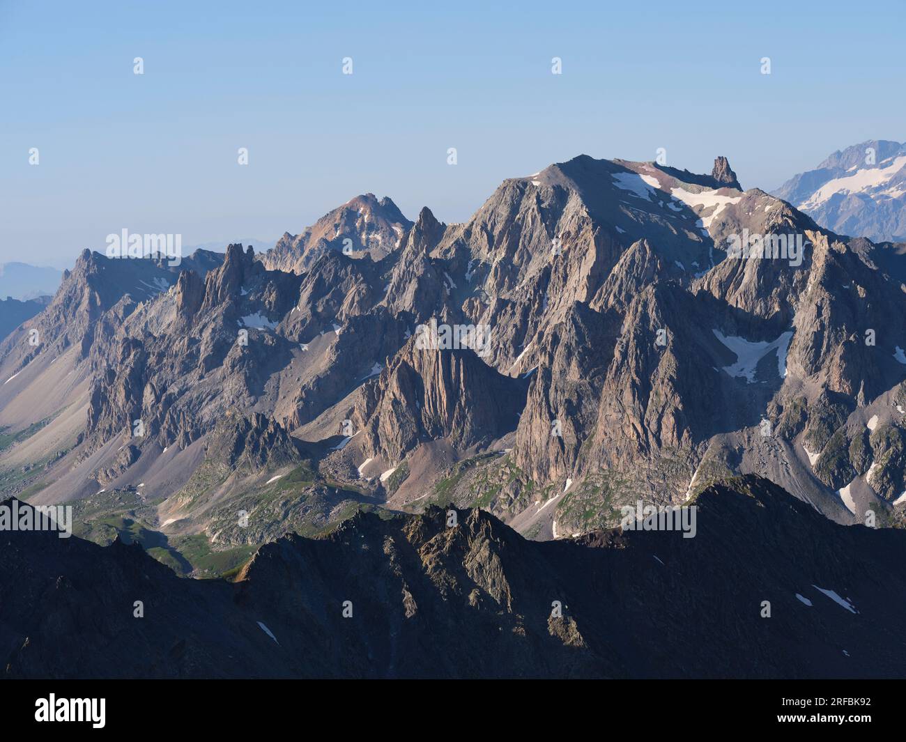 AERIAL VIEW. Cerces Massif in the morning light viewed from the north. Névache, Hautes-Alpes, Provence-Alpes-Côte d'Azur, France. Stock Photo