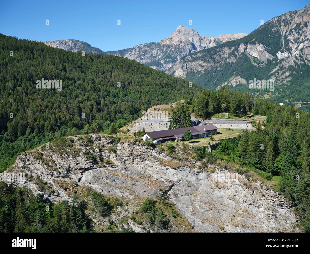 AERIAL VIEW. Bramafam Fort, a military fortification on a clifftop overlooking the upper Susa Valley. Bardonecchia, Metropolitan City of Turin, Italy. Stock Photo