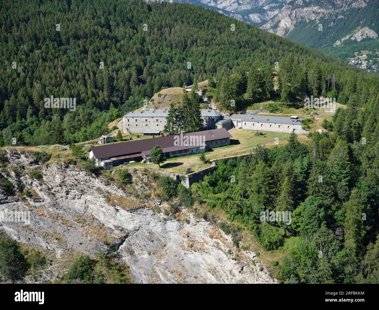 AERIAL VIEW. Bramafam Fort, a military fortification on a clifftop overlooking the upper Susa Valley. Bardonecchia, Metropolitan City of Turin, Italy. Stock Photo