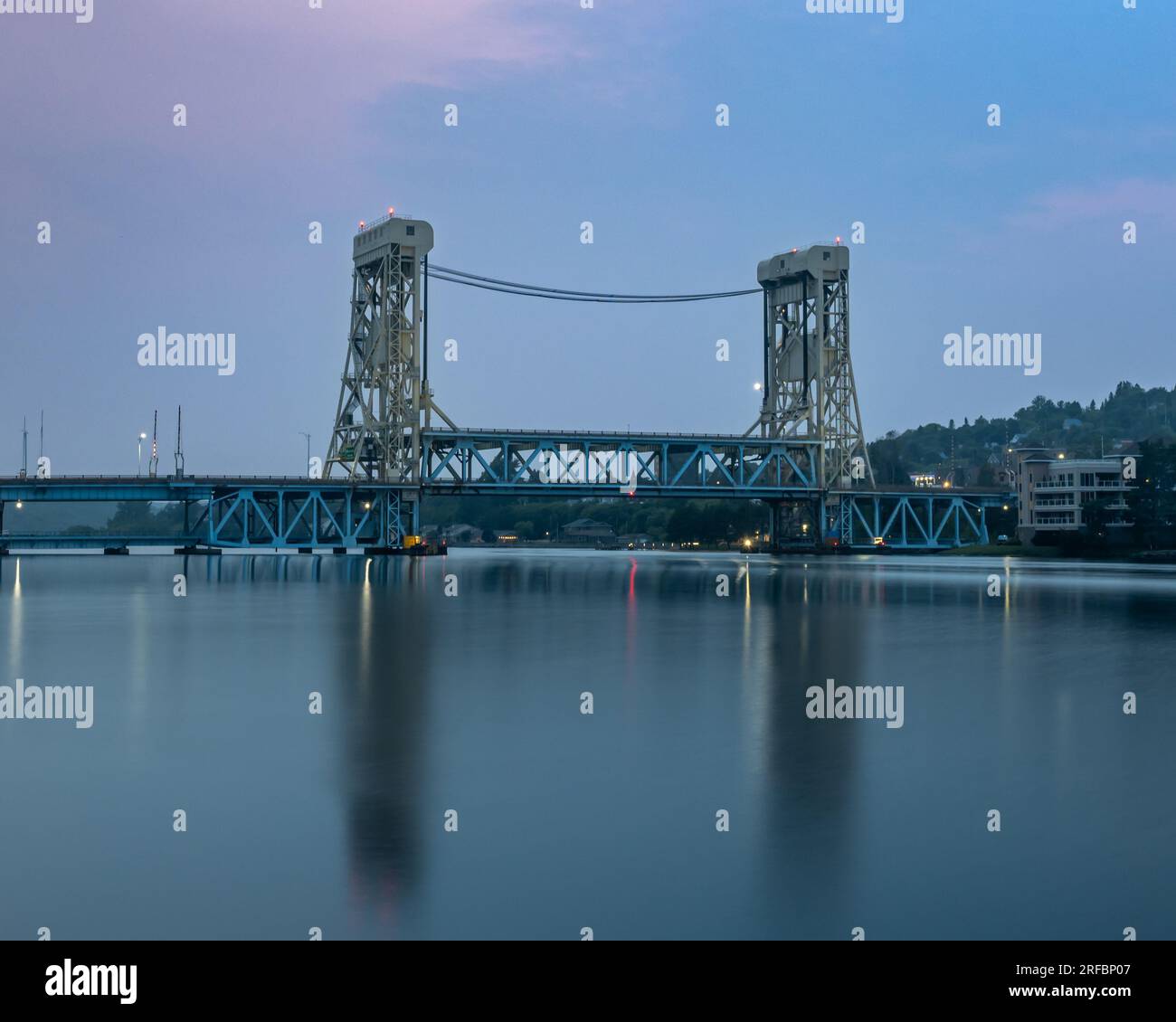 Dusk settles over the Portage Lake Lift Bridge, from Bridgeview  Park, in the Keweenaw Waterway, Houghton, Michigan. Stock Photo