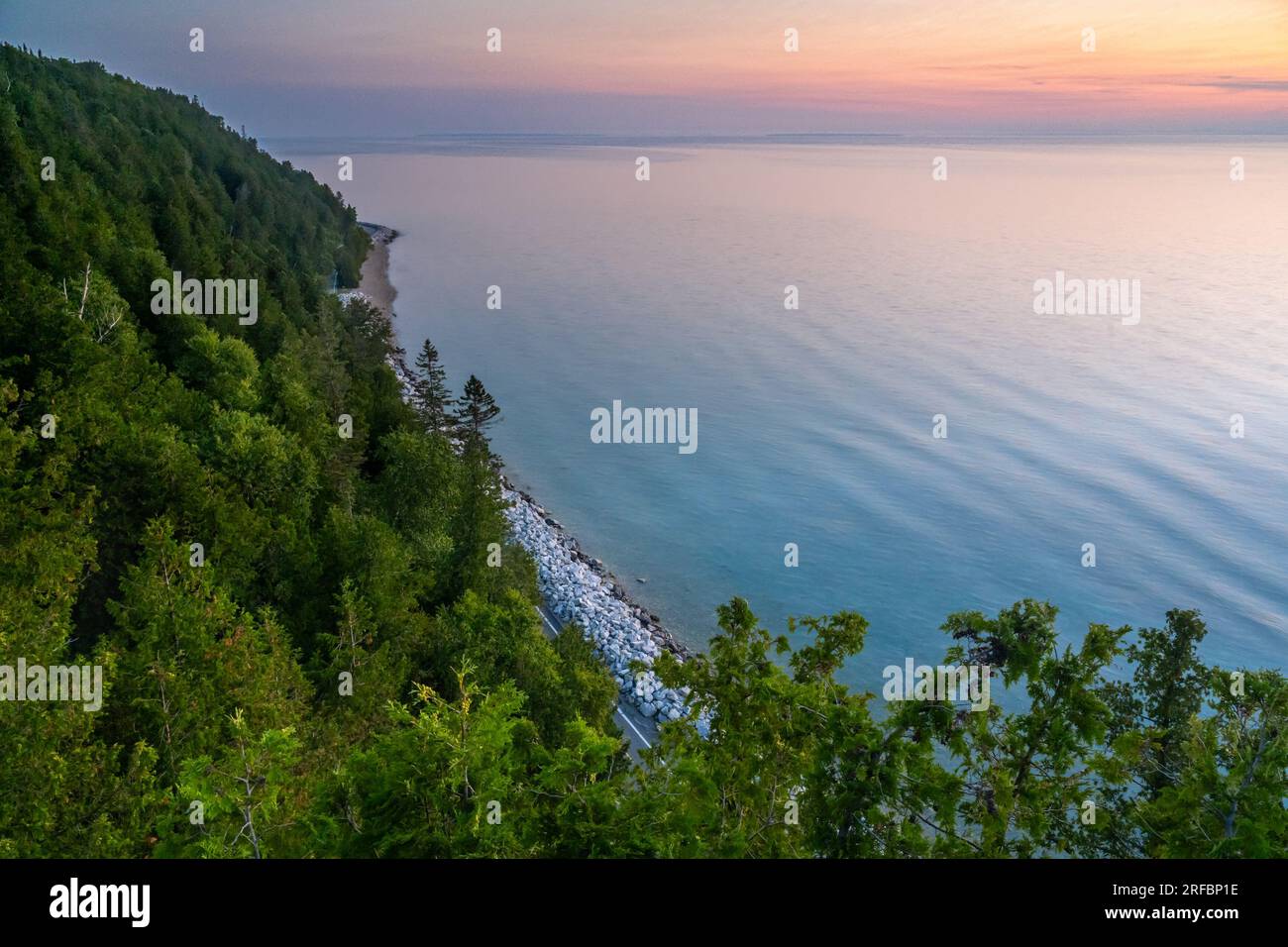 Dawn breaks over Lake Huron, from Arch Rock Viewpoint, on Mackinac Island, Michigan. Stock Photo