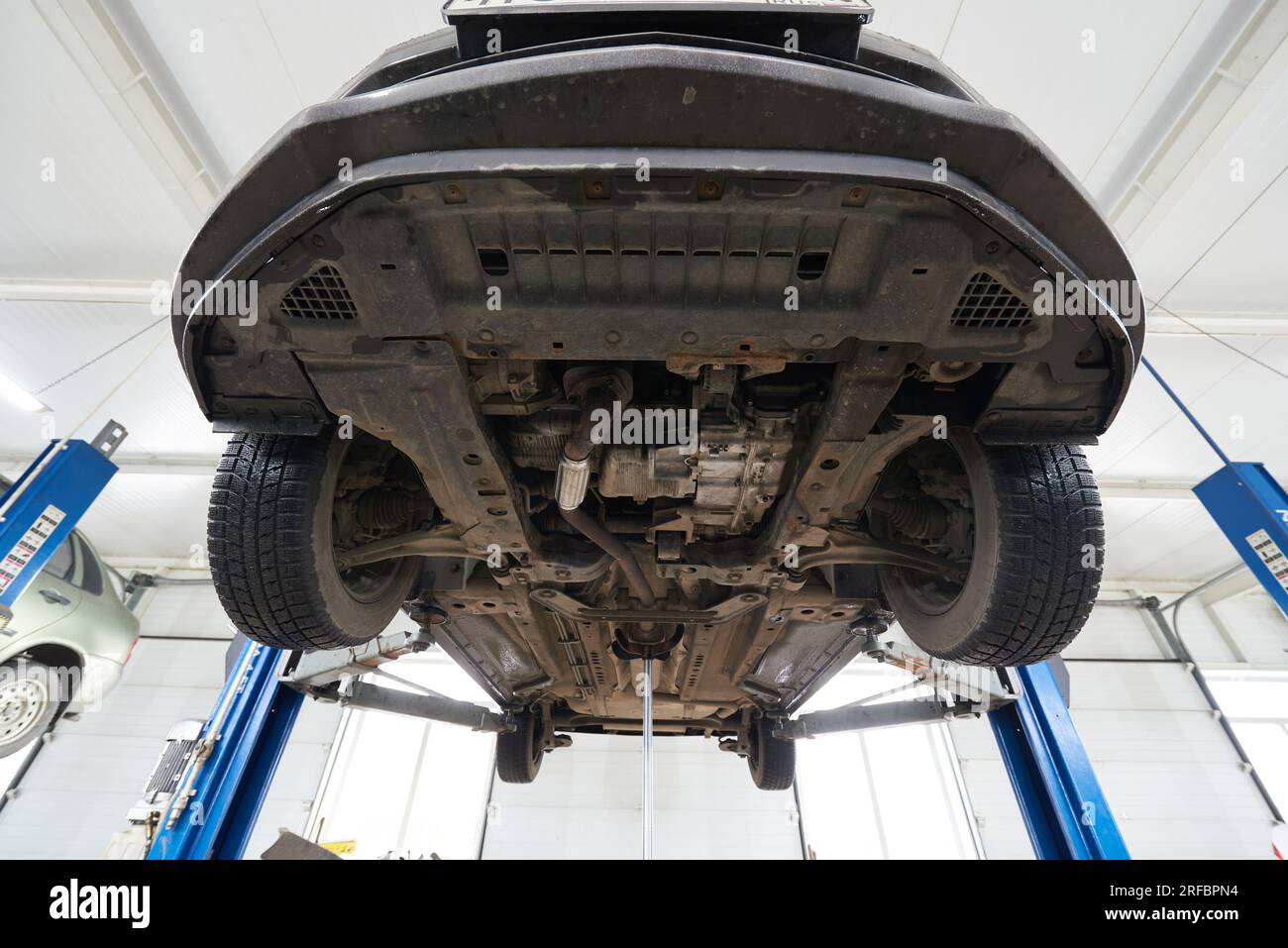 Car on the lift in the service center, bottom view Stock Photo