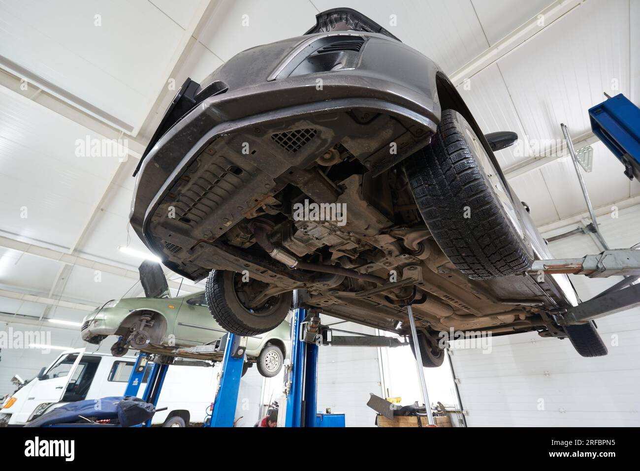 Car on the lift in the service center, bottom view Stock Photo