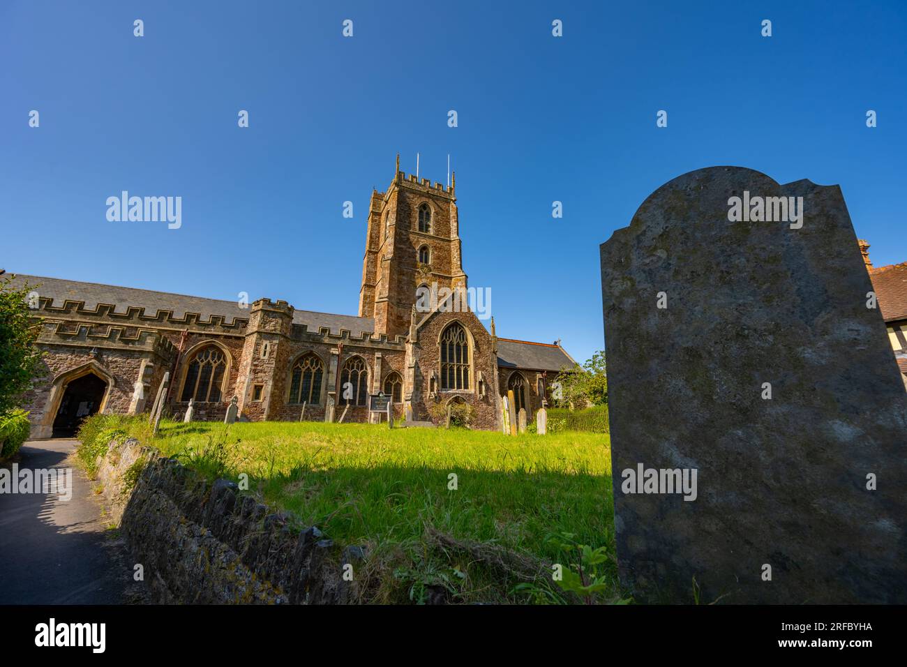 The tower and churchyard of St Georges church Dunster, Somerset Stock ...