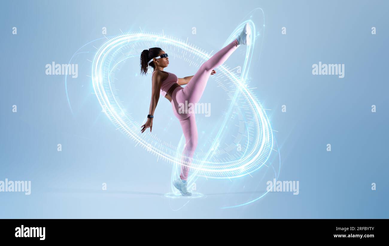 Black woman training self-defence, using VR headset Stock Photo