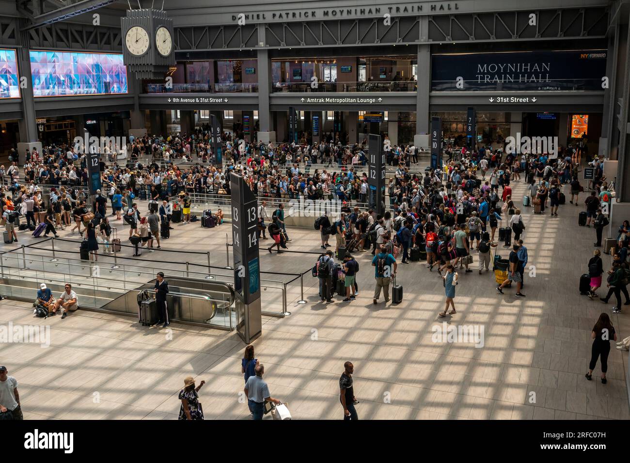 Travelers crowd the Moynihan Train Hall in Pennsylvania Station in New York on Thursday, July 27, 2023, getting an early start to a summer weekend. (© Richard B. Levine) Stock Photo
