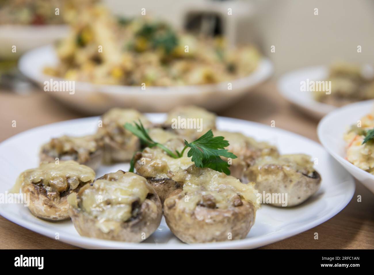Stuffed mushrooms baked with cheese. Traditional Polish Christmas dish on the table. Stock Photo