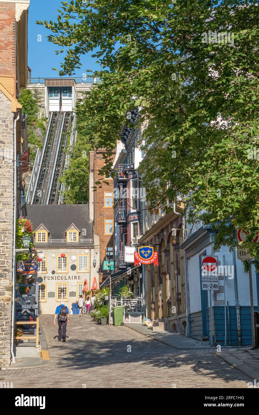 Narrow street in Old Quebec City.  A funicular as seen in the background allows easier transportation from Lower to Upper Town. Stock Photo
