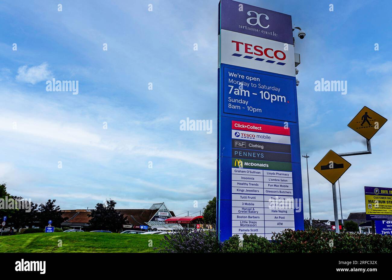 Signage for the Artane Castle Shopping Centre off Kilmore Road, Dublin, Ireland. Businesses include Tesco, Penneys, 3 Mobile, An Post, etc. Stock Photo