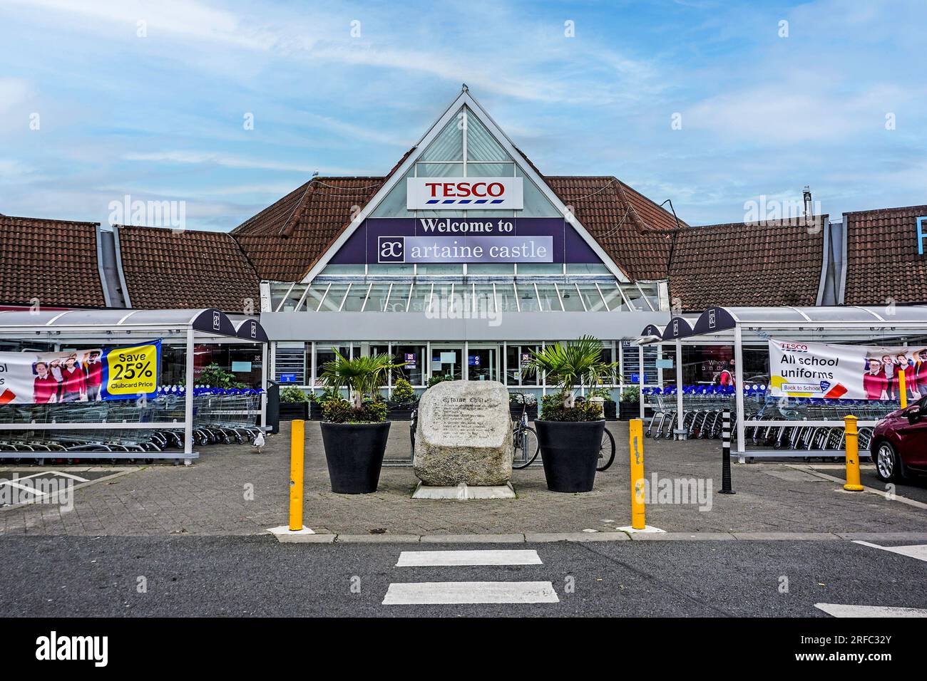 the entrance to the Artane Castle Shopping Centre off Kilmore Road, Dublin, Ireland. The large stone provides a brief history of the original castle. Stock Photo