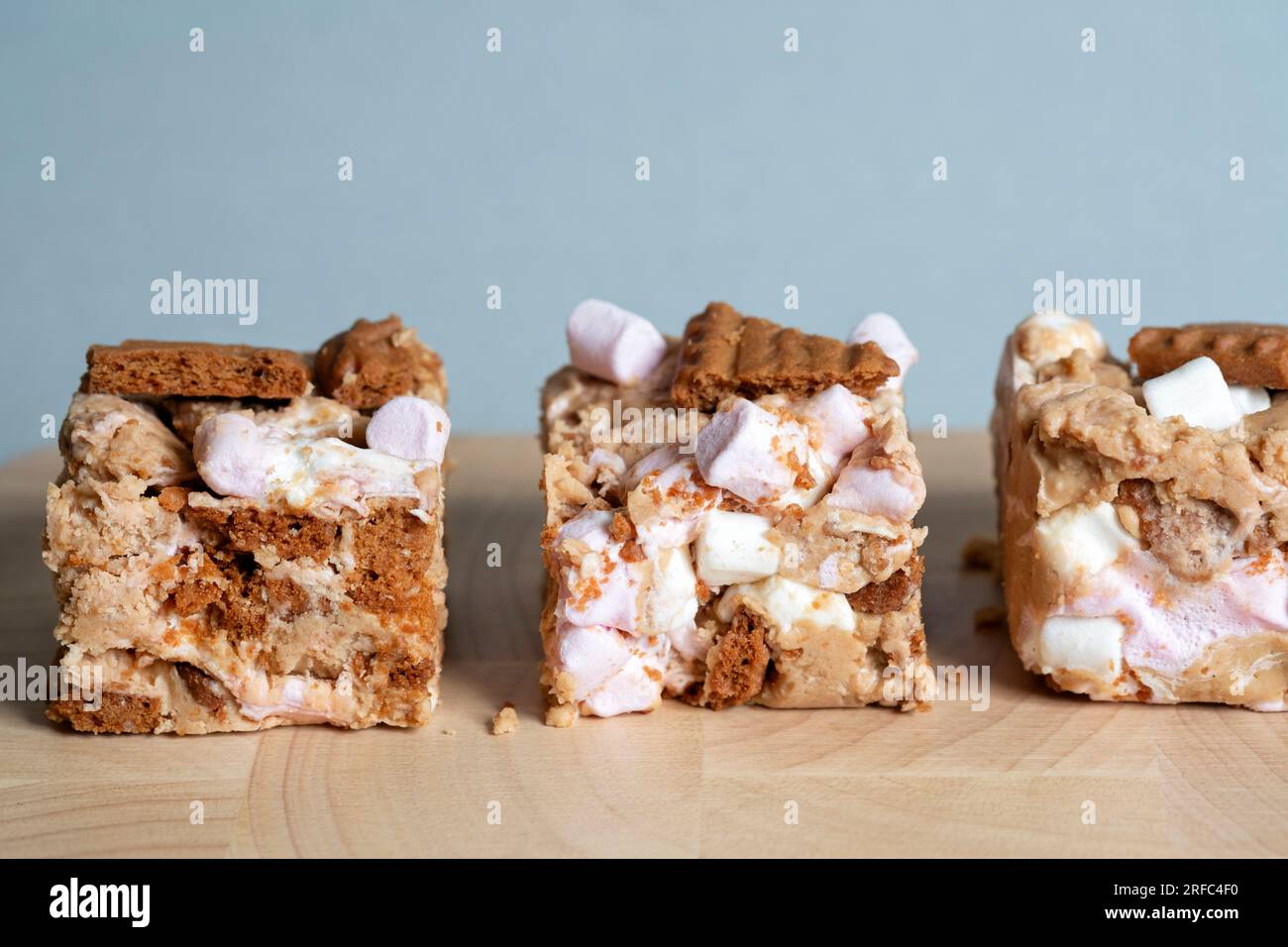 Portions or servings of Biscoff Rocy Road. An indulgent tasty Tiffin made with Biscoff spread, Biscoff biscuits, white chocolate and  marshmallows. Stock Photo
