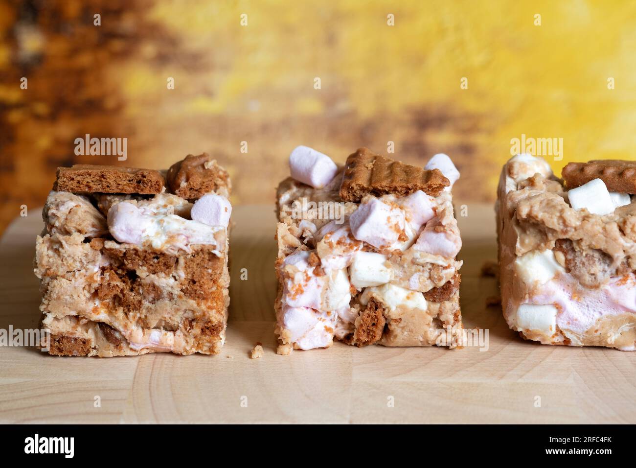 Portions or servings of Biscoff Rocky Road. An indulgent tasty Tiffin made with Biscoff spread, Biscoff biscuits, white chocolate and  marshmallows. Stock Photo