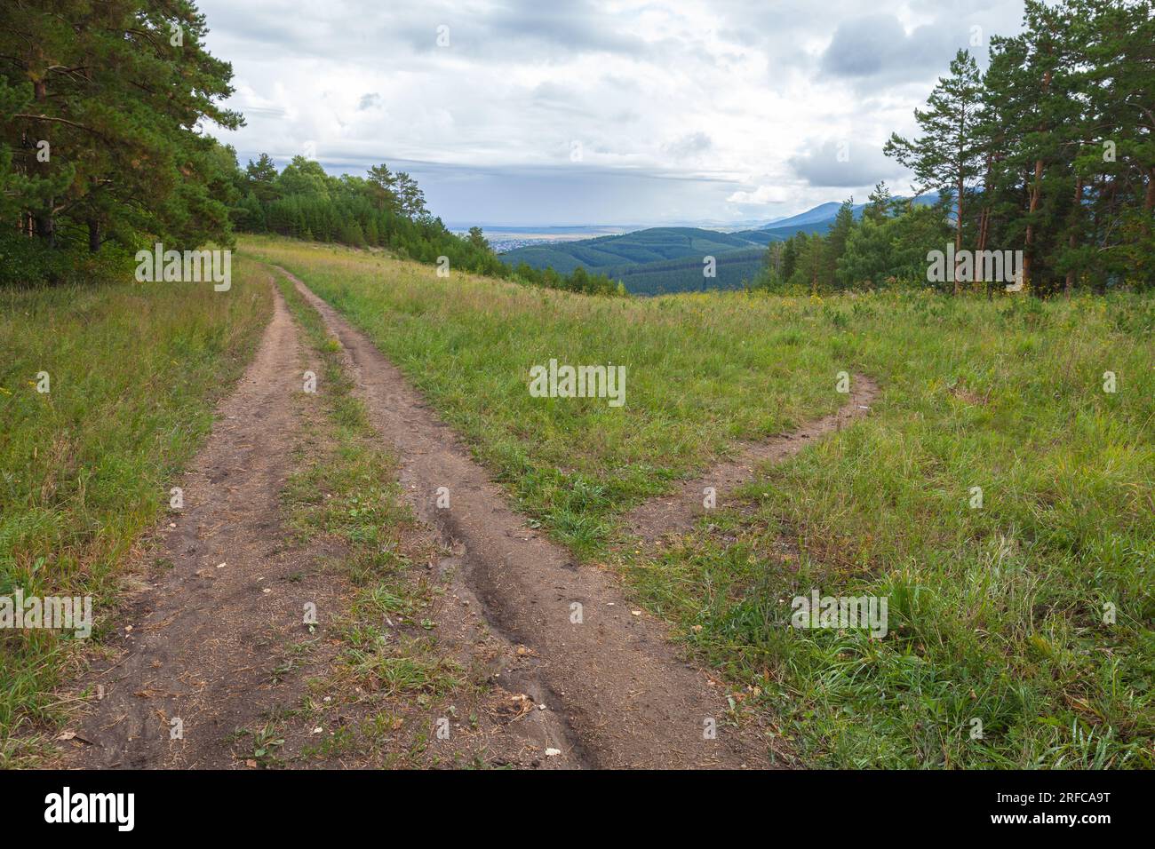 Rural Russian landscape with divergent roads. Belokurikha. The road to the Mount Tserkovka. Stock Photo