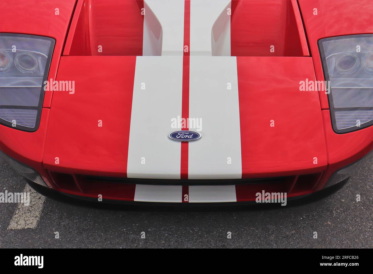 Red & white Ford GT 2005 parked in a parking lot. Stock Photo