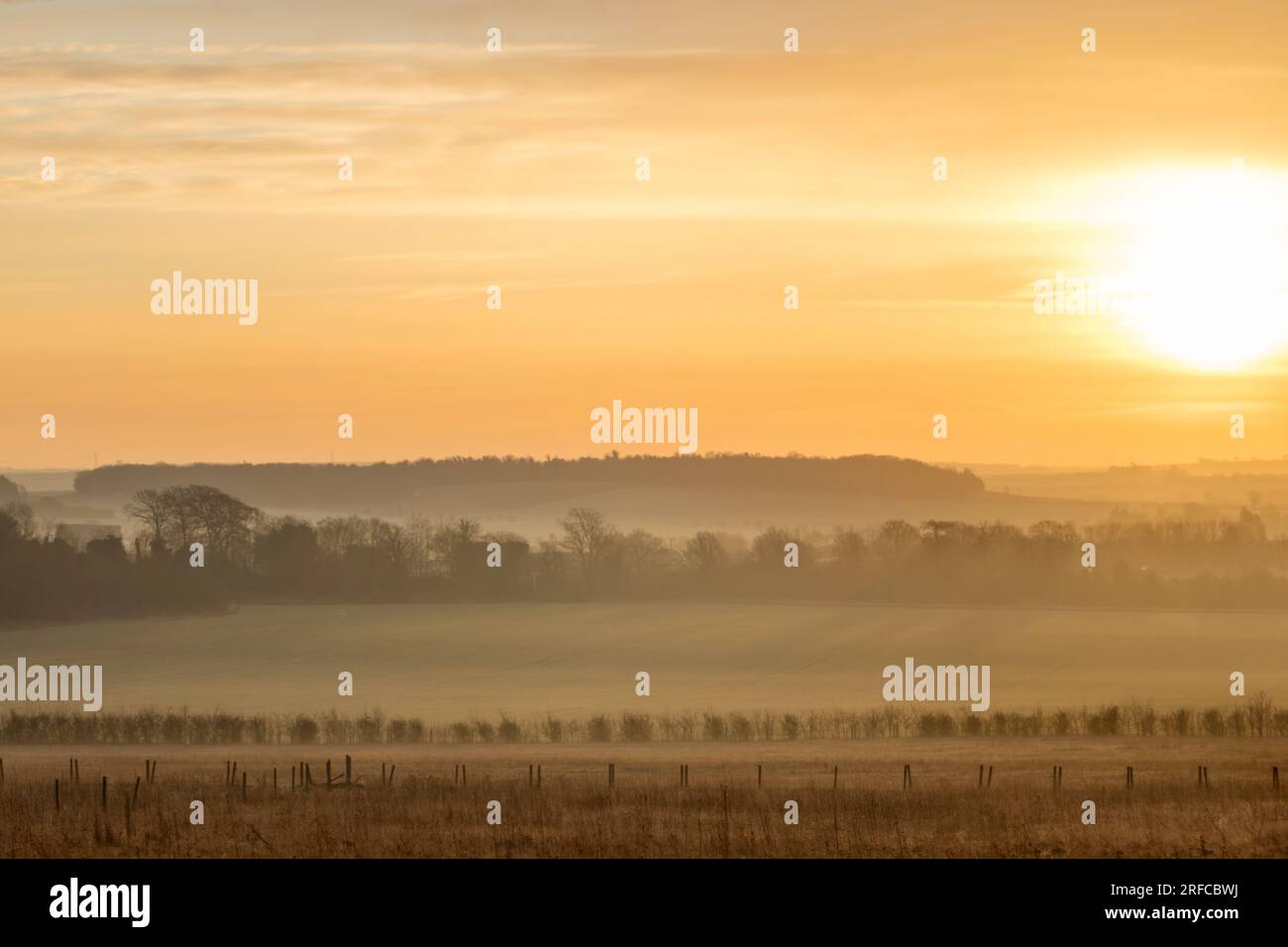 Misty sunrise looking from the Gog Magog Hills towards Linton, Cambridgeshire Stock Photo