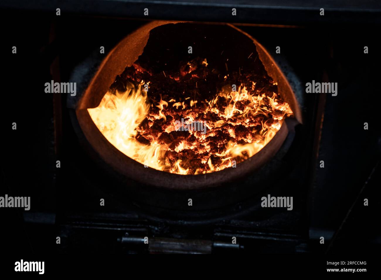 A close up view of a steam train firebox where fuel is burned over grates to produce heat to boil the water in the locomotive boiler Stock Photo