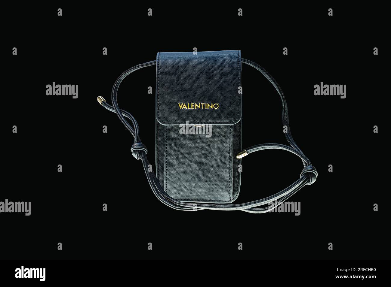 Close-up view of black handbag for mobile phone from Valentino isolated on black background. Sweden. Stock Photo