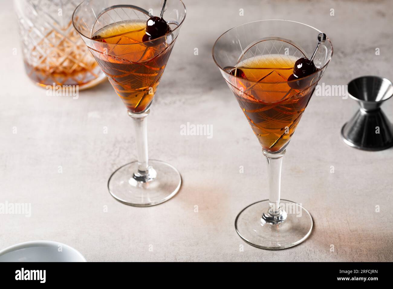 Boozy Classic Manhattan drink bourbon whiskey, vermouth and aromatic bitters garnish with cherries Stock Photo