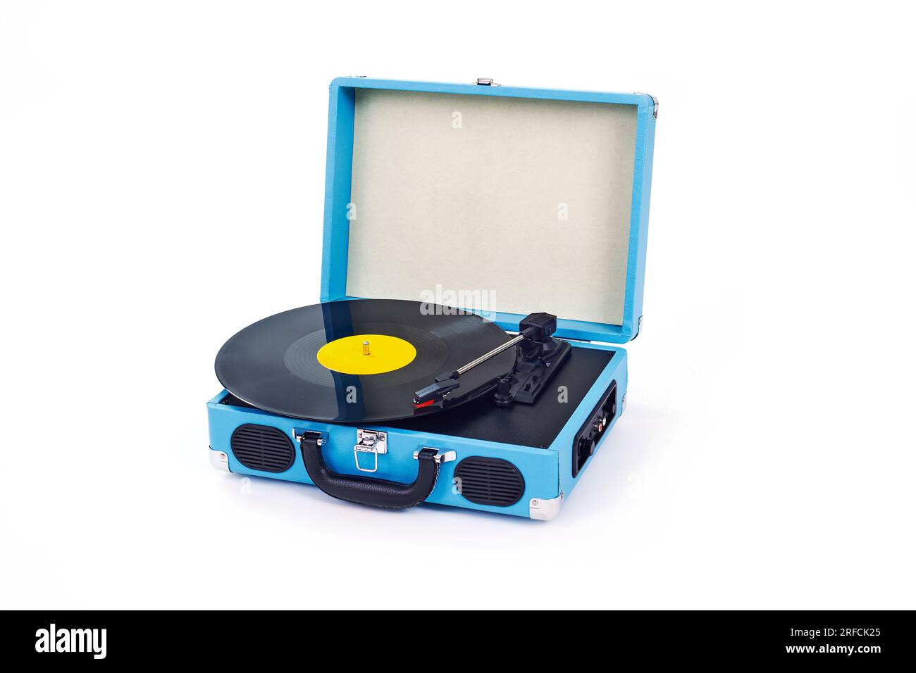 closeup of a blue retro portable turntable playing a disc on a white background Stock Photo