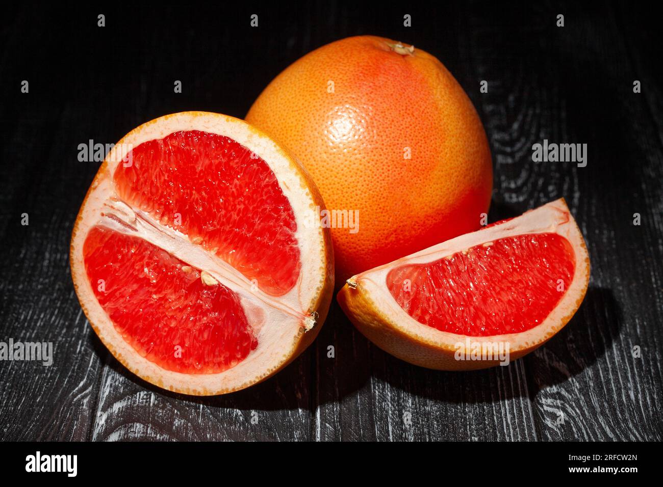 sliced grapefruit on wood background Stock Photo
