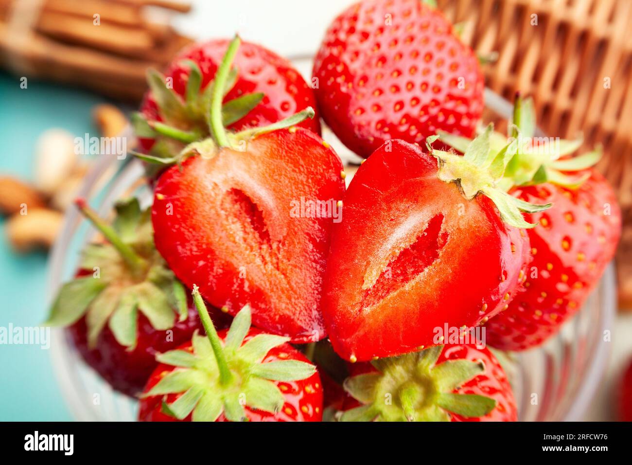 sliced strawberry on wood background Stock Photo - Alamy