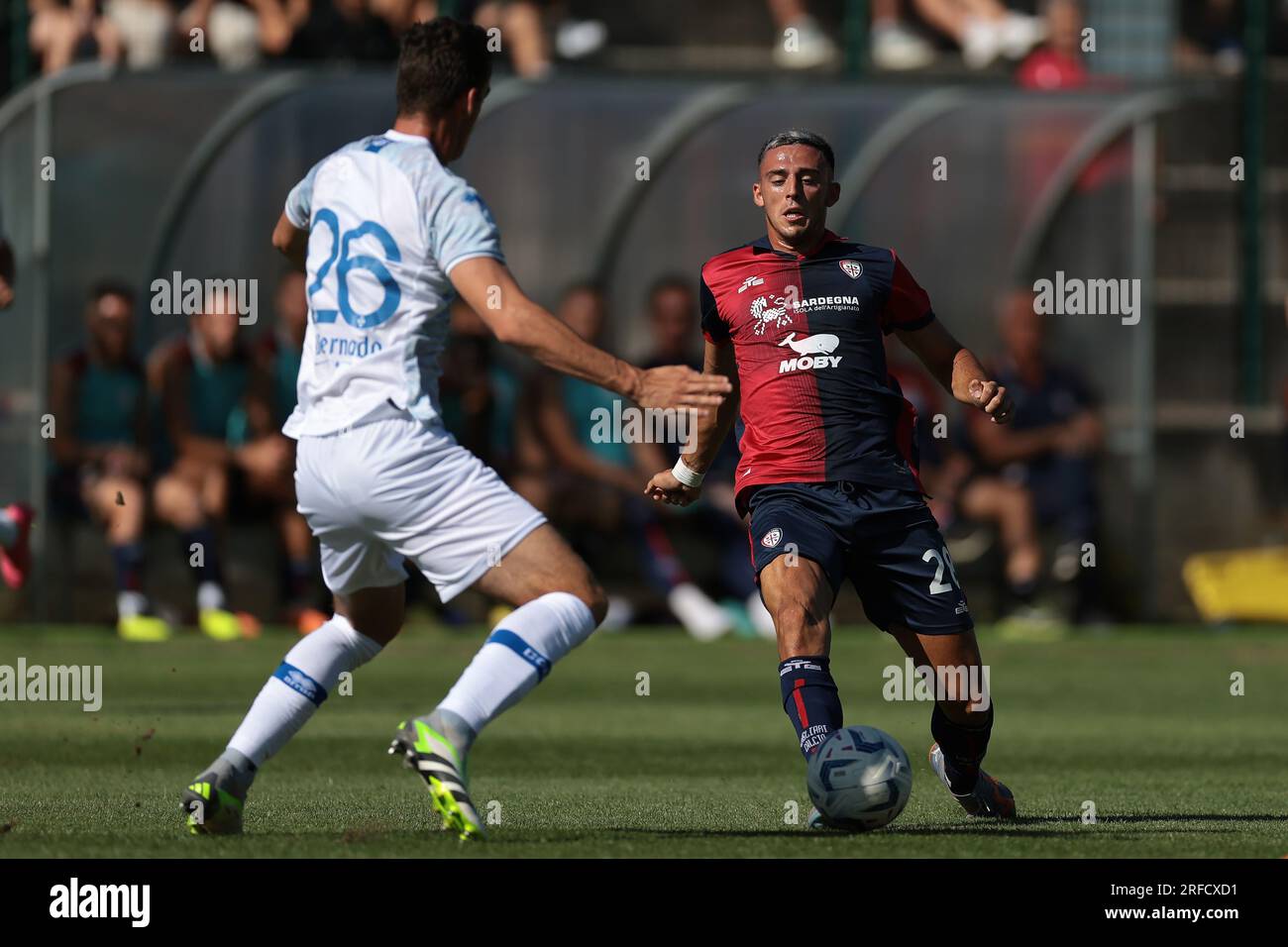 Chatillon, Italy. 2nd Aug, 2023. Gabriele Zappa of Cagliari pokes the ball beyond Can Odenthal of Como during the Pre Season Friendly match at Stadio Comunale, E. Brunod. Picture credit should read: Jonathan Moscrop/Sportimage Credit: Sportimage Ltd/Alamy Live News Stock Photo