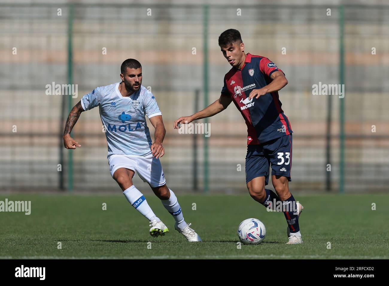 Chatillon, Italy. 2nd Aug, 2023. Adam Obert of Cagliari is pursued by Patrick Cutrone of Como during the Pre Season Friendly match at Stadio Comunale, E. Brunod. Picture credit should read: Jonathan Moscrop/Sportimage Credit: Sportimage Ltd/Alamy Live News Stock Photo