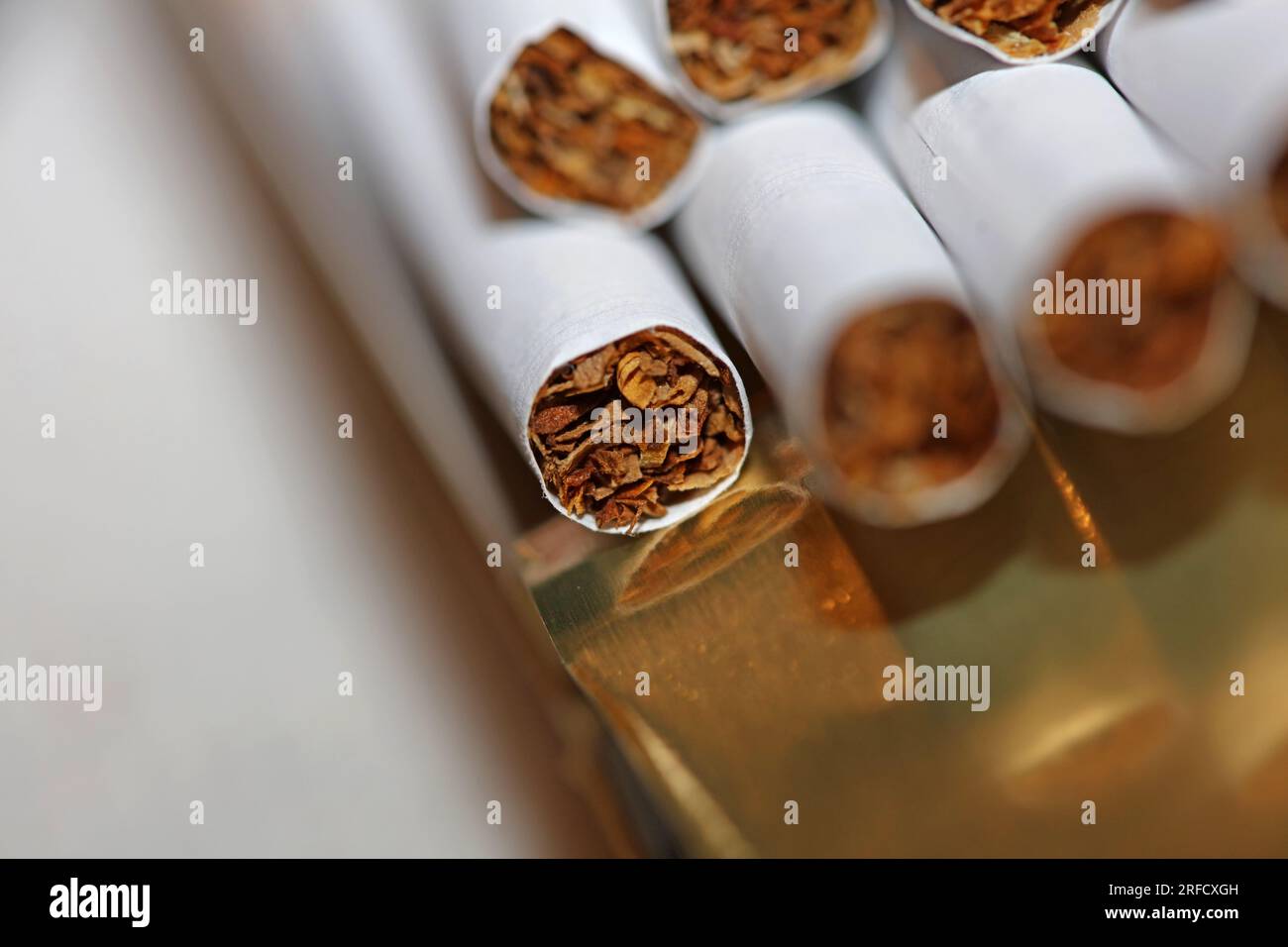 Many cigarettes in colorful background close up of a roll tobacco in paper with filter tube no smoking concept image of several commercially made ciga Stock Photo