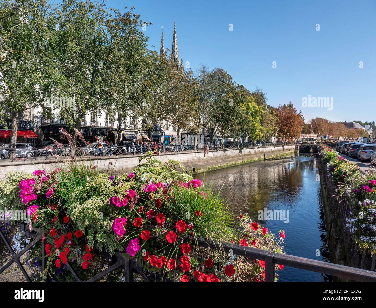 Quimper Town floral view down the River Odet with landmark Gothic-style Quimper Cathedral Saint Corentin twin spires in b/g Quimper Brittany France Stock Photo