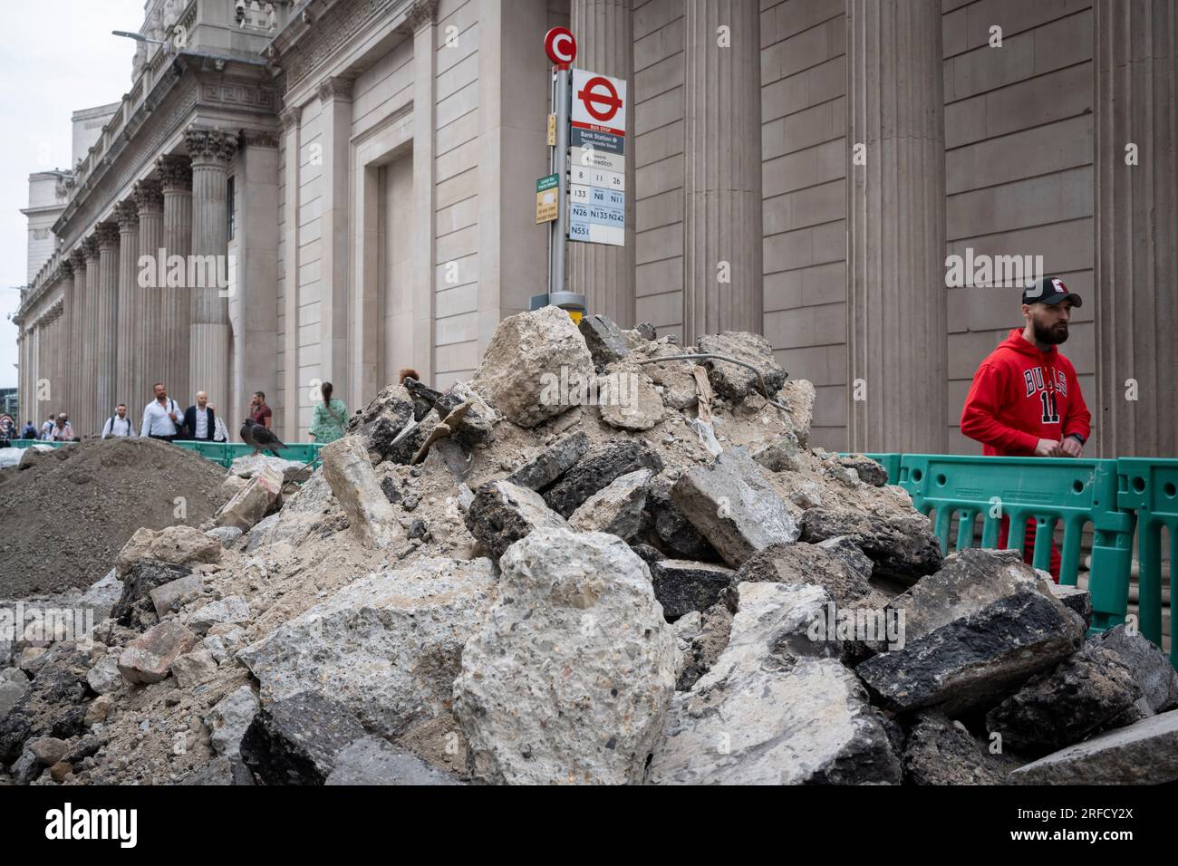 A heap of concrete rubble is piled up beneath the tall pillars and columns of the Bank of England's architecture on Threadneedle Street in the City of London, the capital's financial district, on 26th July 2023, in London, England. Stock Photo
