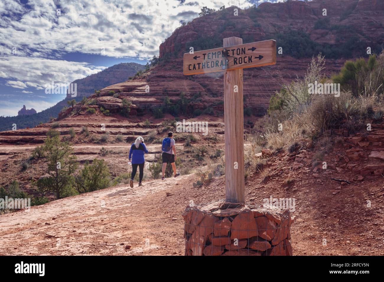A middle aged couple start to walk on a trail in the Red Rocks state park in Sedona Arizona USA Stock Photo