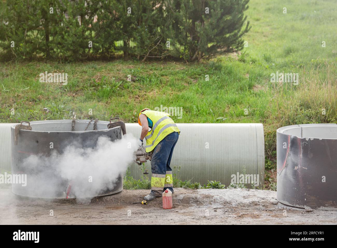 Installing a concrete pipe in the ground to collect rainwater. The