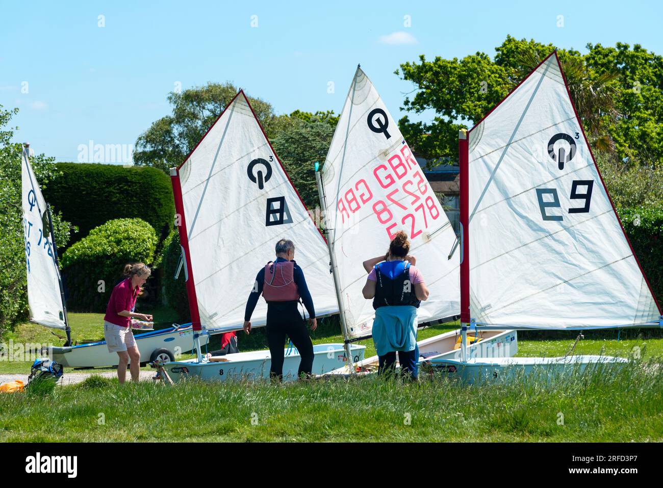 Optimist sailing dinghies preparing to be sailed at the West Wittering Sailing Club, Snowhill, near Chichester, West Sussex, England Stock Photo