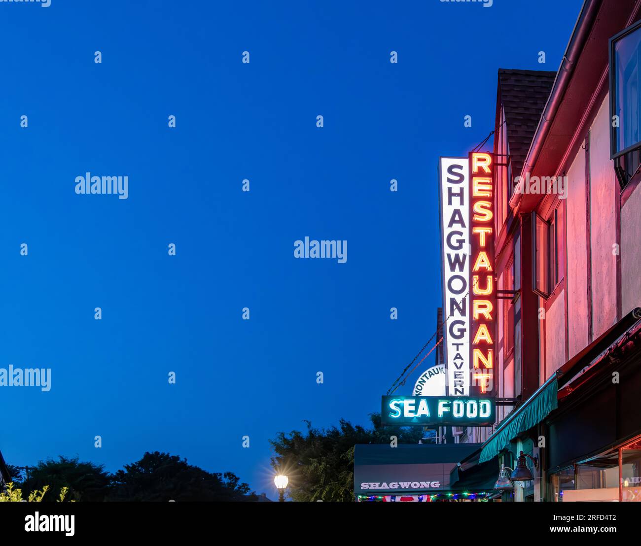 the signs for the Shagwond Tavern in Montauk at night Stock Photo