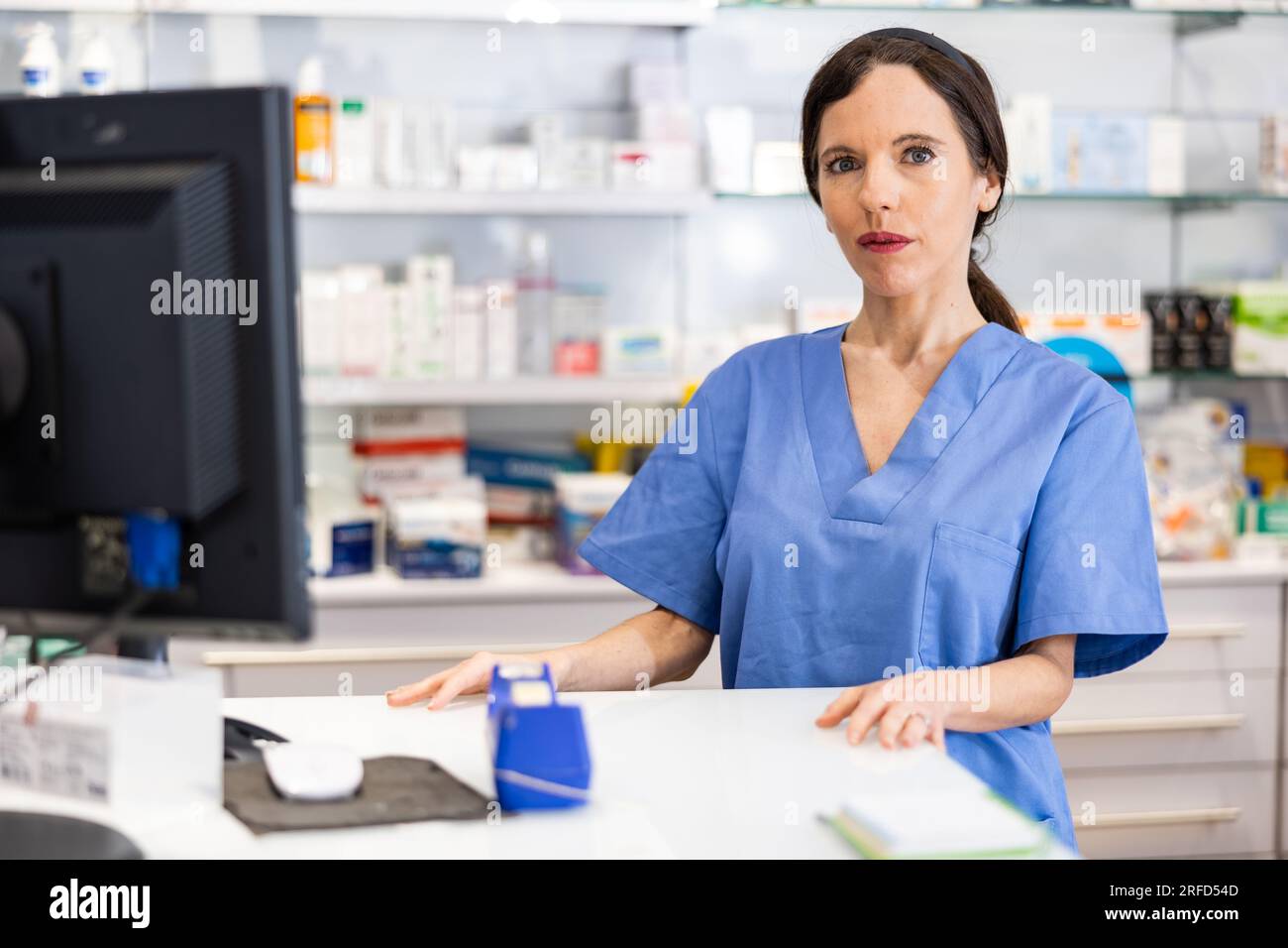 Female pharmacist behind counter hi-res stock photography and images ...