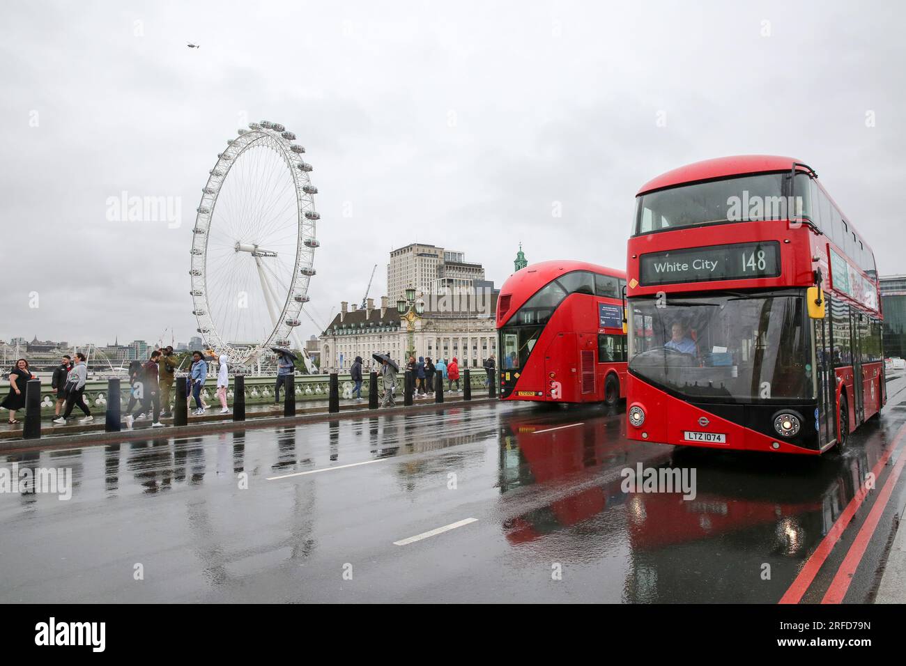 London, UK. 2nd Aug, 2023. People brave the rain on Westminster Bridge in London, Britain, on Aug. 2, 2023. A yellow alert for storms stretching from London to Manchester and covering much of the Midlands and Wales was issued by the Met Office on Wednesday. Credit: Xinhua/Alamy Live News Stock Photo