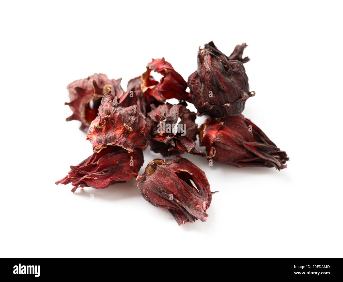 Hibiscus tea on a white background close-up. Dry flowers of red hibiscus on isolation. A handful of hibiscus for making tea. Stock Photo