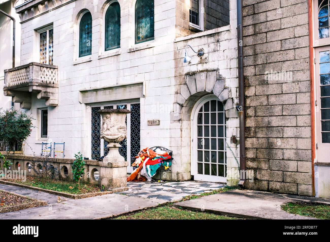 NEW ORLEANS, LA, USA - JANUARY 12, 2023: Deflated Christmas decorations in a chair in front of historic home on Exposition Boulevard Stock Photo