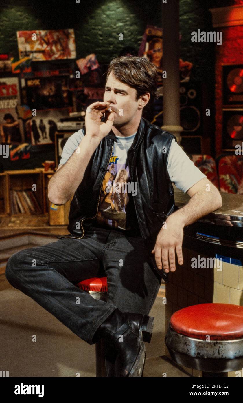 Commedian/Actor Dan Aykroyd on MusicTelevision - MTV - set in 1982. Bernard Gotfryd photograph. Daniel Edward Aykroyd  is a Canadian actor, comedian, screenwriter, producer, and musician. Aykroyd was a writer and an original member of the 'Not Ready for Prime Time Players' cast on the NBC sketch comedy series Saturday Night Live from its inception in 1975 until his departure in 1979. During his tenure on SNL, he appeared in a recurring series of sketches, particularly featuring the Coneheads and the Blues Brothers. Stock Photo