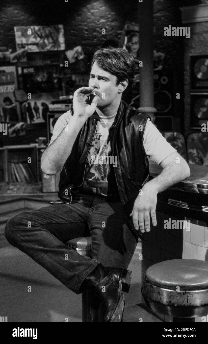 Commedian/Actor Dan Aykroyd on MusicTelevision - MTV - set in 1982. Bernard Gotfryd photograph. Daniel Edward Aykroyd  is a Canadian actor, comedian, screenwriter, producer, and musician. Aykroyd was a writer and an original member of the 'Not Ready for Prime Time Players' cast on the NBC sketch comedy series Saturday Night Live from its inception in 1975 until his departure in 1979. During his tenure on SNL, he appeared in a recurring series of sketches, particularly featuring the Coneheads and the Blues Brothers. Stock Photo