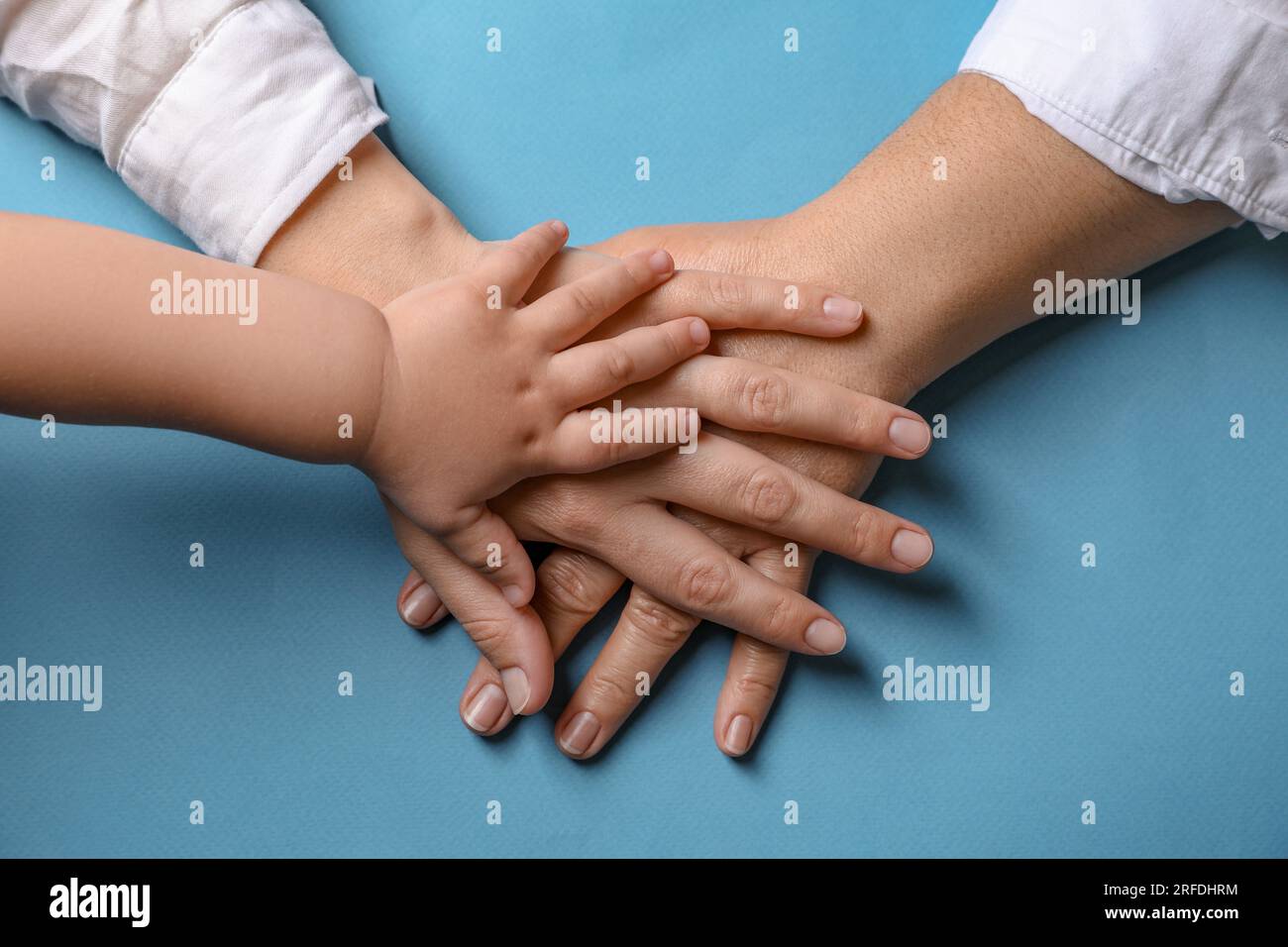 Family holding hands together on light blue background, top view Stock ...