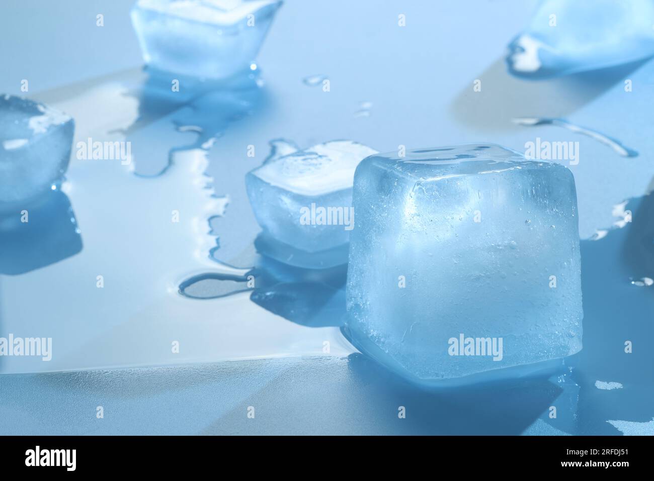Crystal clear ice cubes on light blue background Stock Photo - Alamy